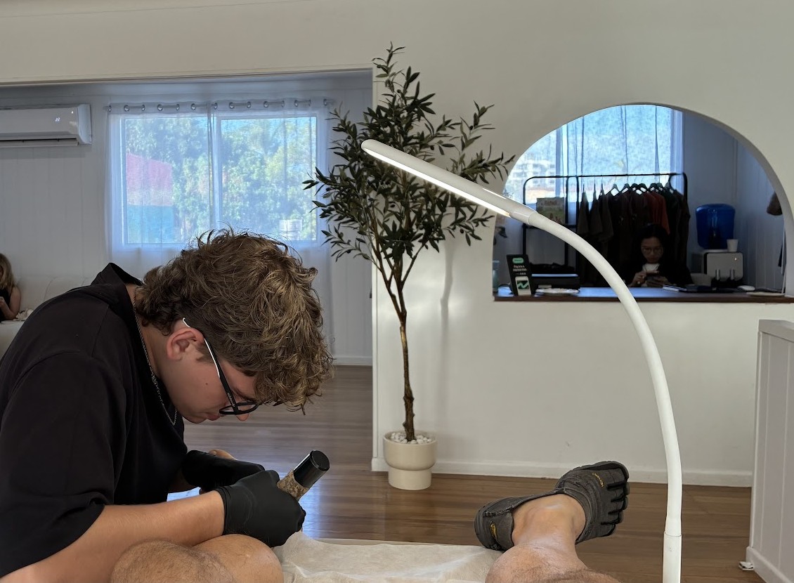 A La Femme artist working carefully on a client's foot in the bright studio